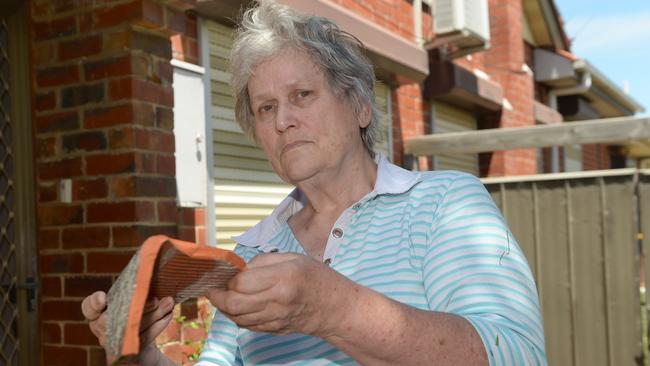 Elsbeth Jones, 72, with broken tiles from her roof. Picture: Susan Windmiller