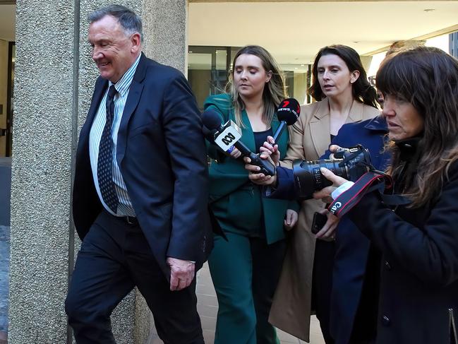 Tim Mathieson refuses to answer reporters’ questions as he leaves his lawyer’s office. Picture: Luis Enrique Ascui