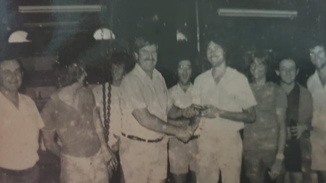 Max Tomlinson presents Tony Raggatt with a pen at the Northern Miner in Charters Towers.