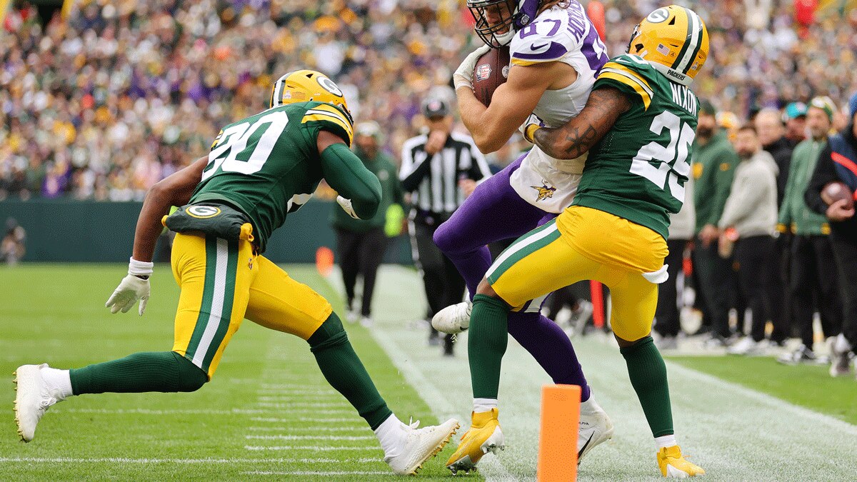 T.J. Hockenson #87 of the Minnesota Vikings is tackled by Keisean Nixon #25 of the Green Bay Packers after a reception at Lambeau Field on October 29, 2023 in Green Bay, Wisconsin. (Photo by Michael Reaves/Getty Images)