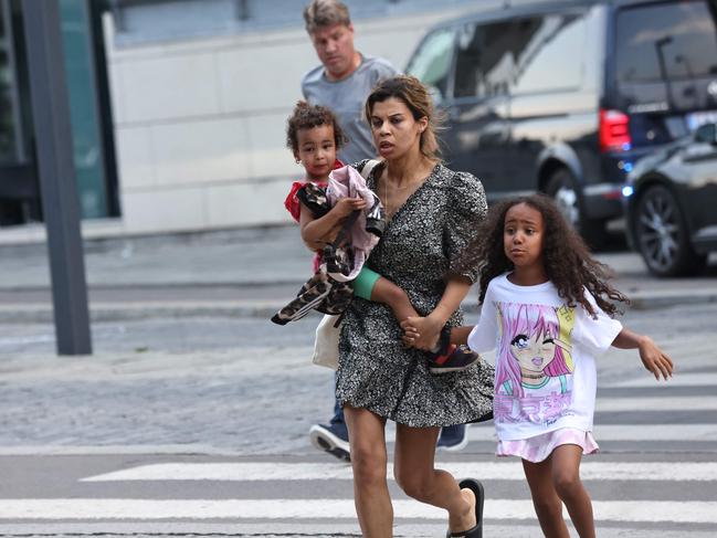 People are seen running during the evacuation of the Fields shopping center in Copenhagen, Denmark after Danish media reported a shooting. Picture: AFP / Denmark OUT