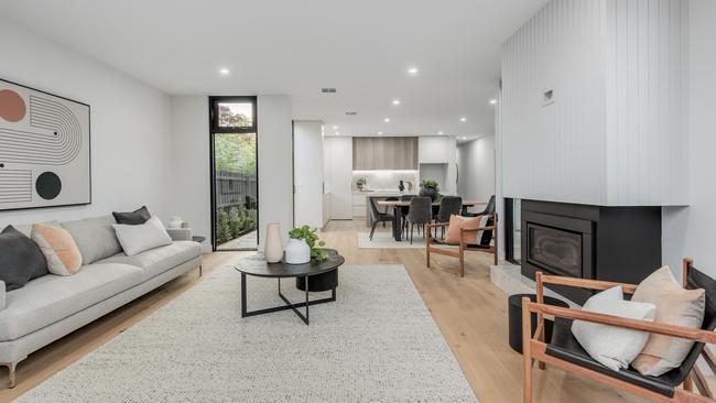 The large open-plan living and dining area with a built-in gas fireplace.