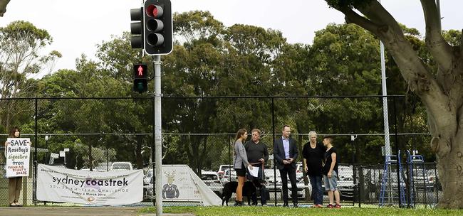 L to R: Diane Davie, Bella Starr, John Starr (with Tess the dog) , Greens State MLC member David Shoebridge, Nicola Grieve, and Belinda Johnstone stand between the affected trees. Woollahra Council has approved the removal of two very old fig trees on New South head road Rose Bay, as they are starting to compromise the surface of the tennis courts. Picture: John Appleyard