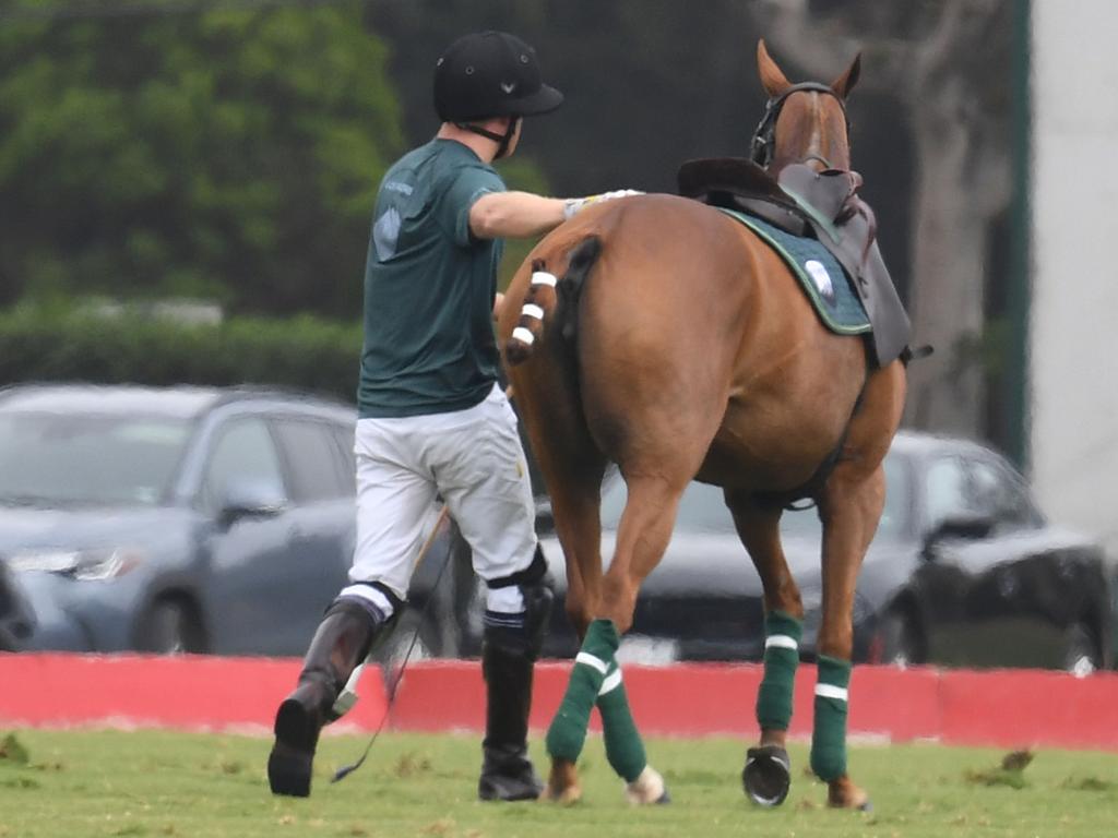 Prince Harry gets to his feet after his fall at the Santa Barbara Polo and Racquet Club. Picture: GAC / MEGA TheMegaAgency.com