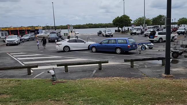 Dramatic footage shows a man towing a Toyota out of a trailer bay at Jacobs Well Boat Ramp on Saturday after it had blocked him in. Photo: Landos Down Under