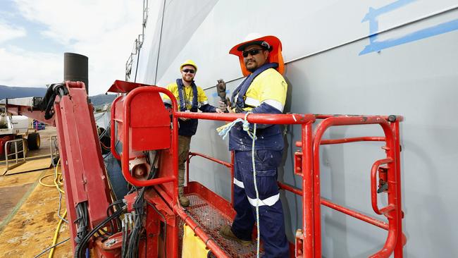 British Navy ship HMS Spey has docked at the Tropical Reef Shipyard for maintenance work, the first time a British warship has undergone maintenance at the Port of Cairns. Marine workers Tupoumatatika Meremere and Dyfan Tinnuche work on the hull on HMS Spey. Picture: Brendan Radke