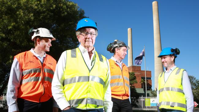 Delta chairman Trevor St Baker (second from left) and managing director Greg Everett (second from right) at Vales point Power Station. Picture: Mark Scott