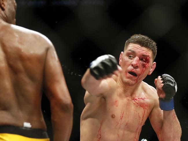 Anderson Silva steps away from a punch by a bloodied Nick Diaz late in their fight at the MGM Grand Garden Arena.