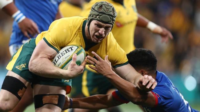 Australia's David Pocock (C) is tackled by Scott Malolua (R) of Samoa. Picture: AFP