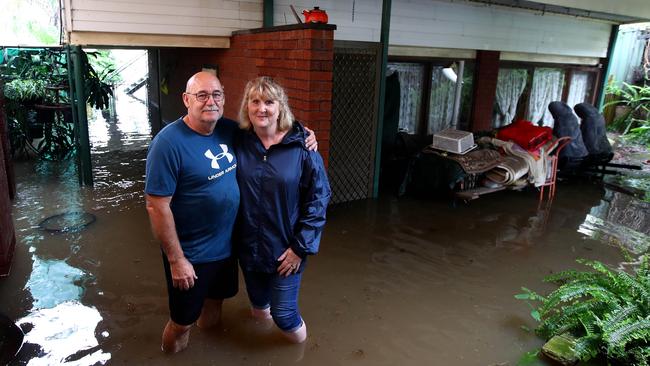 Sydney continues to be drenched in heavy rains causing flooding in local areas and the Warragamba Dam to overflow, sending millions of litres of water down the Nepean River to low lying areas like Emu Plains. Kellee Wilson and husband Steven stand in the rising water that has flooded the lower level of their Bellevue Rd home in Regentville. Picture: Toby Zerna