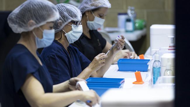 PERTH, AUSTRALIA - APRIL 28: Nurses are seen drawing up doses from a multi-dose vile of AstraZeneca Covid-19 vaccine at Claremont Showground on April 28, 2021 in Perth, Australia. The West Australian Government have opened up two new Vaccine Centres including one at Perth Airport. (Photo by Matt Jelonek/Getty Images)