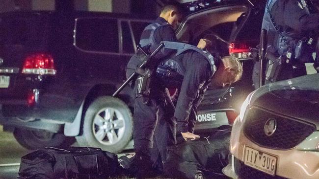 Police in riot gear gather near Lonzo Park in Taylors Hill on August 8. Picture: Jason Edwards