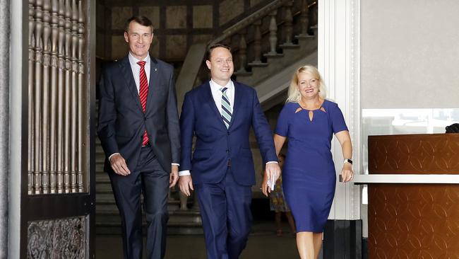 Outgoing mayor Graham Quirk, new Brisbane Lord Mayor Adrian Schrinner and Deputy Mayor Krista Adams walk out of City Hall on Sunday.