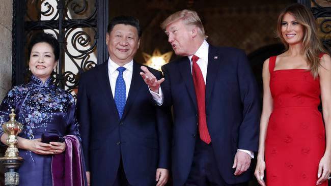 President Donald Trump talks with Chinese President Xi Jinping, flanked by their wives, first lady Melania Trump and Chinese first lady Peng Liyuan during a visit in April. Picture: Alex Brandon/AP