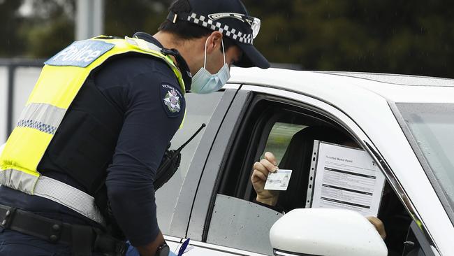 Police and ADF check work permits and identification at a roadblock in Little River. Picture: Daniel Pockett/Getty Images