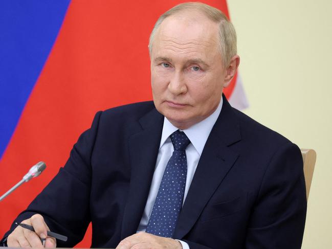 In this pool photograph distributed by Russian state owned Sputnik agency, Russia's President Vladimir Putin chairs a meeting with Russian Government members at the Novo-Ogaryovo residence, on August 7, 2024. (Photo by Valery SHARIFULIN / POOL / AFP) / Editor's note : this image is distributed by Russian state owned agency Sputnik
