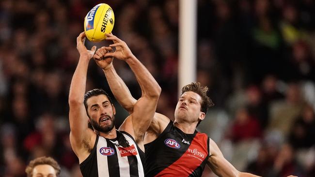 Brodie Grundy flies for a mark against Patrick Ambrose during Collingwood’s win on Friday. Picture: AAP Image/Scott Barbour.