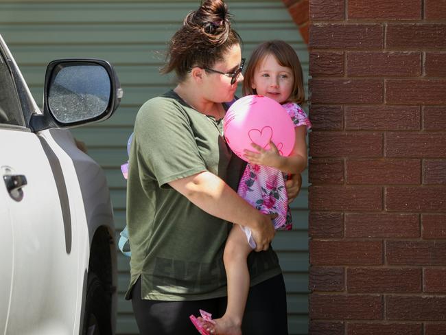 Cleo is carried inside a friend's house by her mother in Carnarvon. Picture: Getty Images