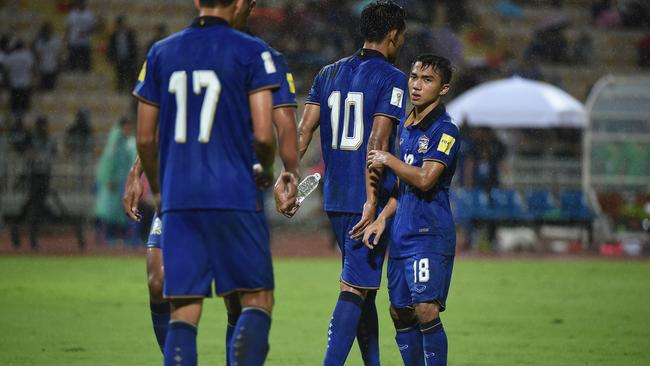 Chanathip Songkrasin with teammates during the 2018 FIFA World Cup Qualifier between Thailand and Japan at the Rajamangala National Stadium.