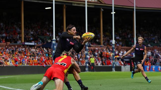 James Aish of the Dockers handballs in front of the Norwood scene. Photo by Paul Kane/Getty Images.