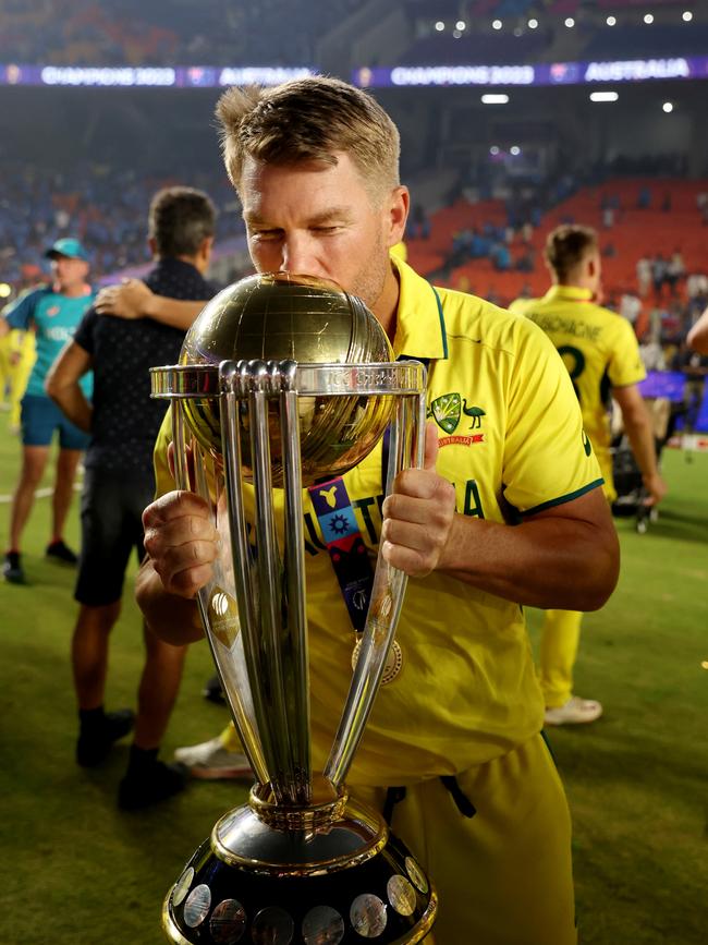 AHMEDABAD, INDIA - NOVEMBER 19: David Warner of Australia poses with the ICC Men's Cricket World Cup Trophy following the ICC Men's Cricket World Cup India 2023 Final between India and Australia at Narendra Modi Stadium on November 19, 2023 in Ahmedabad, India. (Photo by Robert Cianflone/Getty Images)