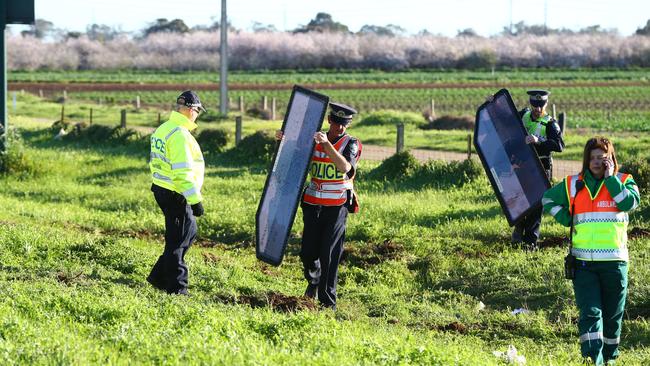 Police remove items from the scene of the accident on Port Wakefield Rd. Picture: Tait Schmaal