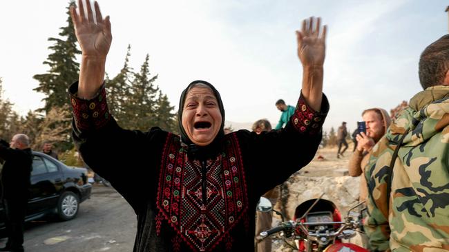 A woman reacts as people gather at Sednaya prison in Damascus looking for loved ones. Syrian rescuers searched the Sednaya jail, synonymous with the worst atrocities of ousted president Bashar al-Assad's rule.