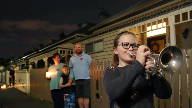 8 year old Audrey Taylor plays the Last Post in front of her home in Richmond. Picture: David Crosling