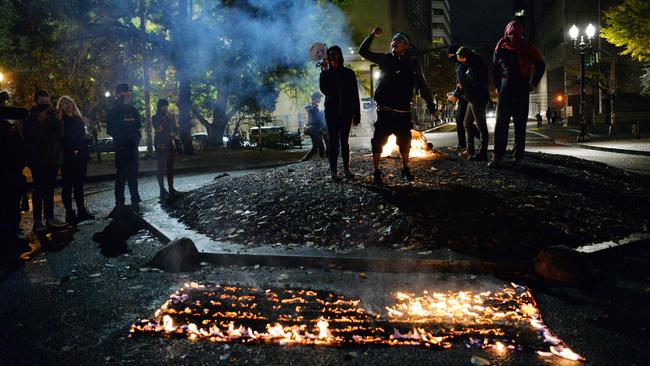 Protesters burn the American flag outside the Mark O. Hatfield United States Courthouse in Portland, Oregon. Picture: AFP