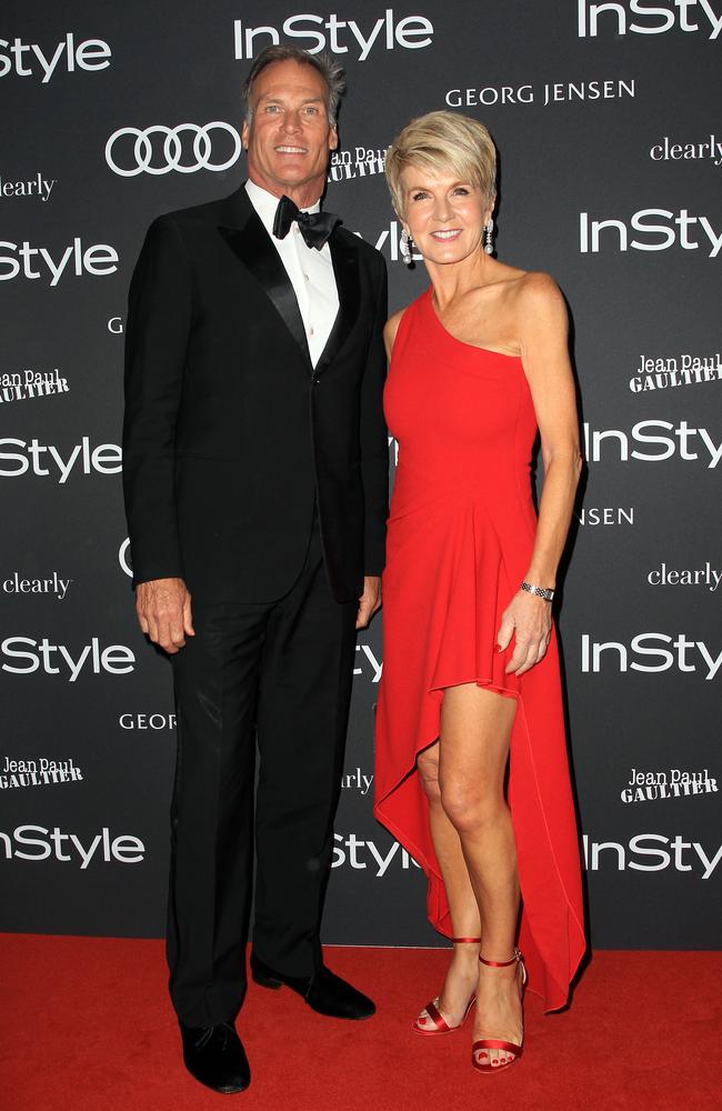 Julie Bishop in a daring red gown alongside partner David Panton. Picture: Christian Gilles