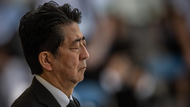 Japan’s Prime Minister, Shinzo Abe, closes his eyes as he observes a moment of silence during the 75th anniversary of the Nagasaki atomic bombing on August 9. Picture: Getty Images