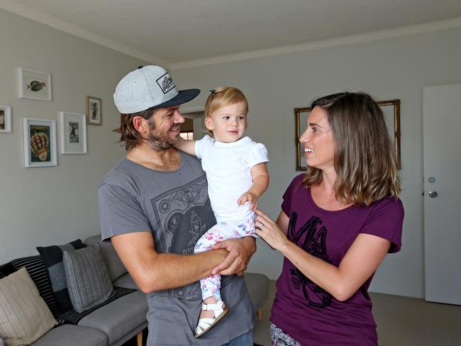 Former pro surfer Dayyan Neve and his wife Kelly (global marketing manager for Mambo) with their 16 month old daughter Coco at their Freshwater apartment that they are selling. MANLY DAILY 12th March 2014. Picture by DAMIAN SHAW