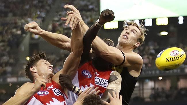 MELBOURNE, AUSTRALIA - APRIL 20: Callum Sinclair of the Swans, Aliir Aliir of the Swans & Tom Lynch of the Tigers compete for the ball during the 2019 AFL round 05 match between the Richmond Tigers and the Sydney Swans at Marvel Stadium on April 20, 2019 in Melbourne, Australia. (Photo by Dylan Burns/AFL Photos)