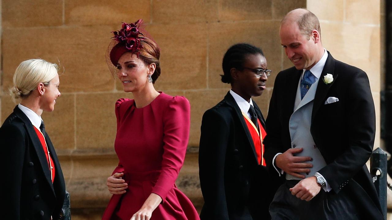 The couple make their way inside ahead of their cousin’s wedding. Picture:  Adrian DENNIS / various sources / AFP