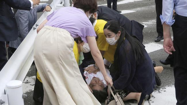 Former Japanese Prime Minister Shinzo Abe lies on the ground after being shot. Picture: Kyodo/Reuters