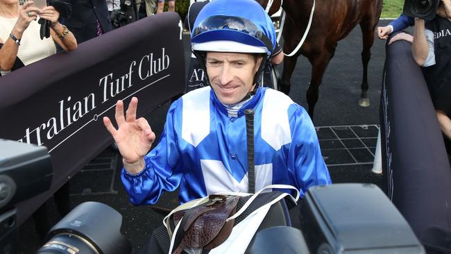 Jockey Hugh Bowman gestures after another win on the great mare. Picture: AFP