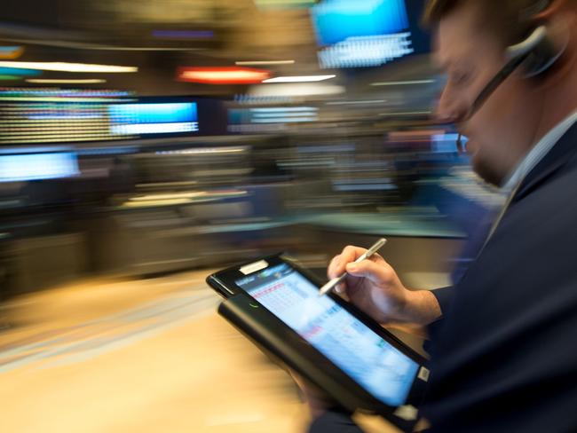 A trader at the New York Stock Exchange in New York where stocks remained negative after the Fed announcement. Picture: AFP