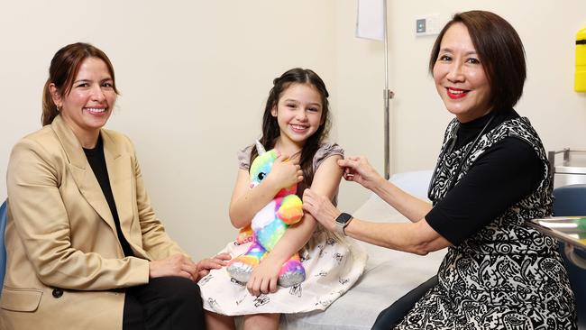 Clara Garzon with her daughter Emily James, 7, who received her flu vaccination from Dr Amy Ho. Picture: Tim Hunter