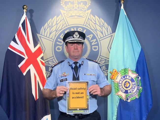 Assistant Commissioner Ben Marcus with the sign he made for Queensland's Road Safety Awareness Week.