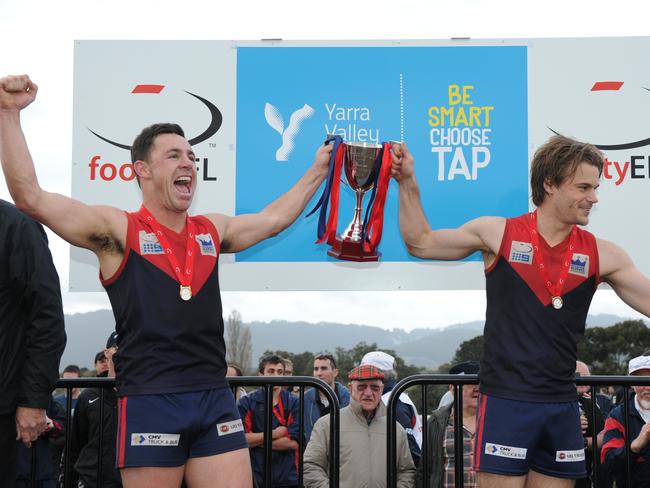 Brett Johnson and captain Dean Stephen hoist the 2013 premiership cup. Picture Lawrence Pinder