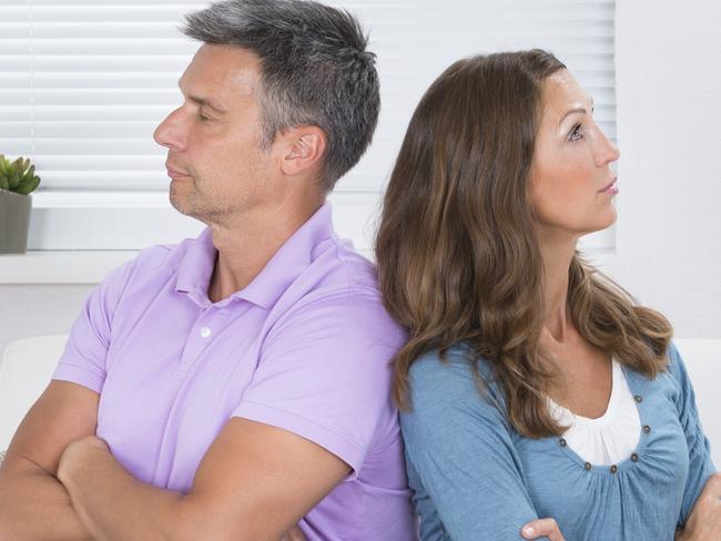 Unhappy Mature Couple With Armcrossed Sitting On Sofa After Quarrel