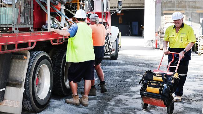 Builders collecting tools and equipment from the Midwater apartment site.