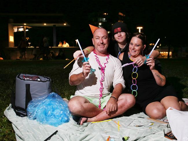 Pete Bright, Deegan Ramage and Megz Bright spend New Year's Eve together on the Cairns Esplanade. Picture: Brendan Radke