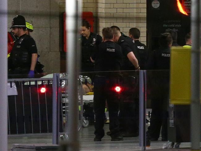 A person is wheeled away on a stretcher at Victoria Railway Station close to the Manchester Arena. Picture: Getty