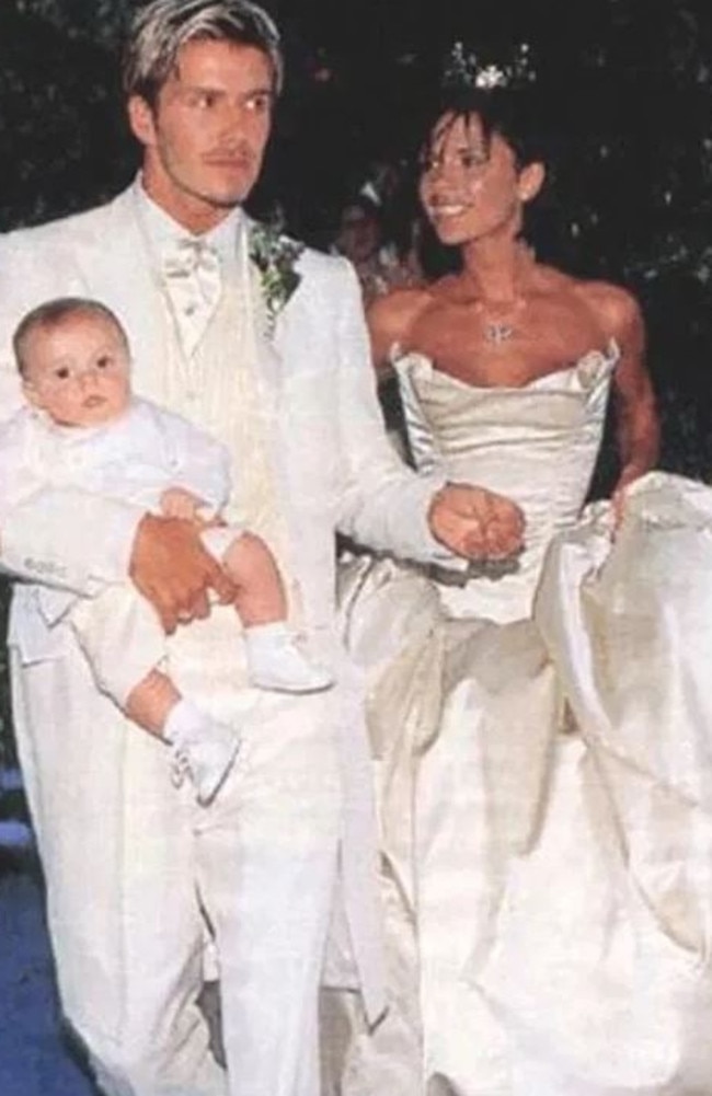 David and Victoria Beckham with baby Brooklyn at their 1999 wedding.