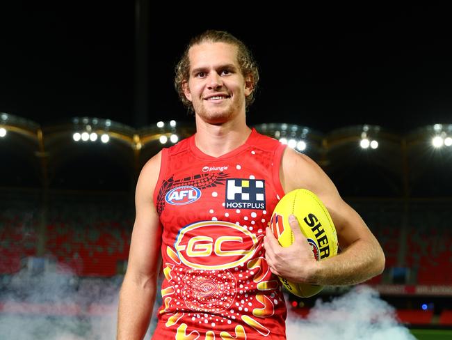 GOLD COAST, AUSTRALIA - MAY 03: Jed Anderson of the Suns  poses with the Gold Coast Suns AFL Indigenous Guernsey at Heritage Bank Stadium on May 03, 2023 in Gold Coast, Australia. (Photo by Chris Hyde/Getty Images)