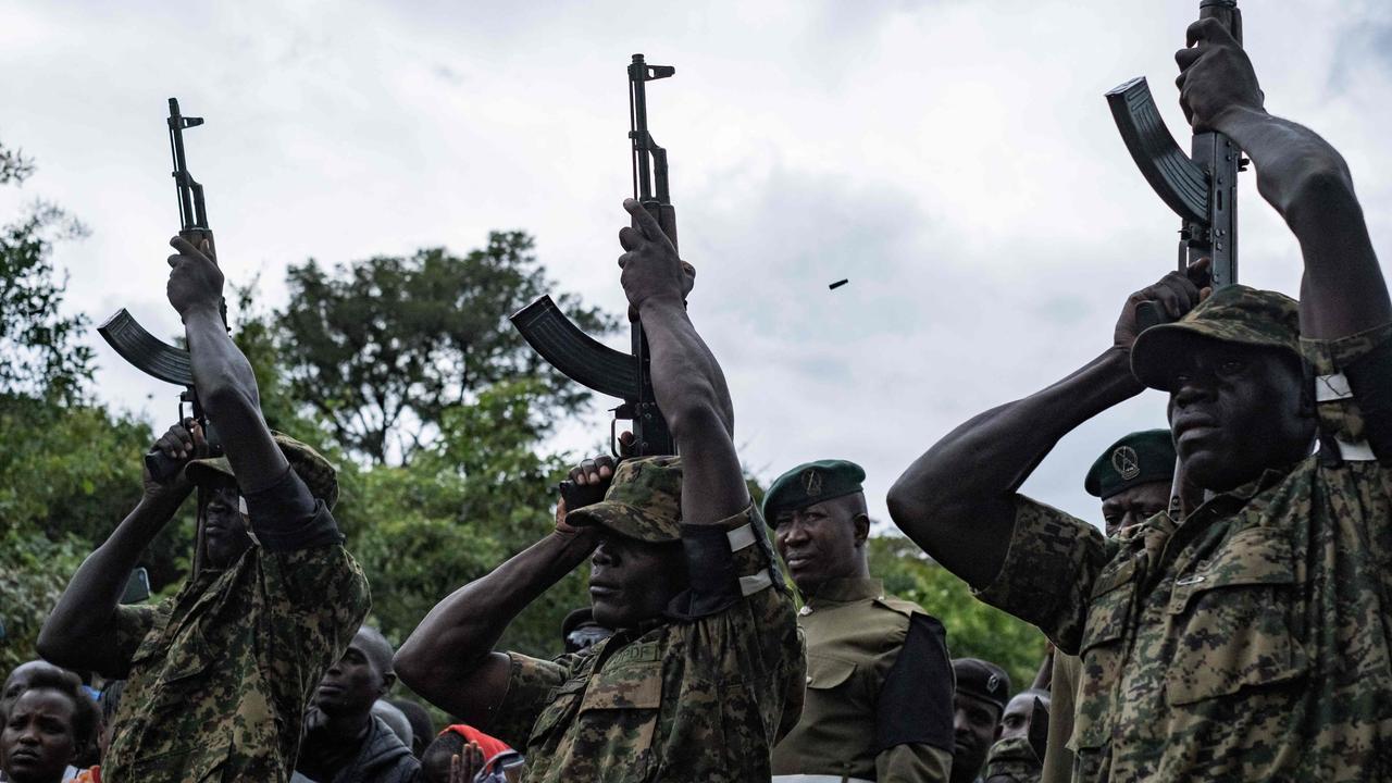 Uganda People's Defense Forces (UPDF) officers salute Rebecca Cheptegei. Photo by BADRU KATUMBA / AFP.