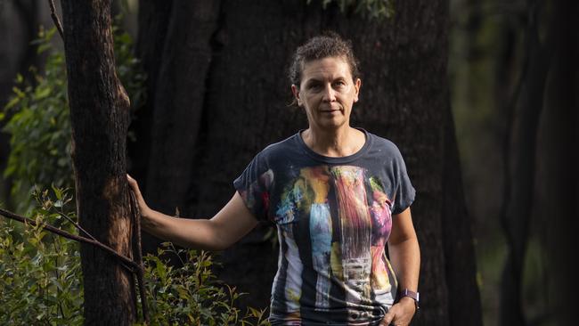 Lisa Groom in the forests of her neighbourhood that were burned in September last year. Picture: Mark Cranitch