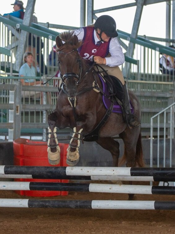 A ride makes her way around the indoor at the PQC State Showjumping Championships 2023.