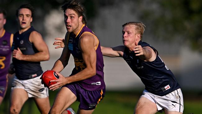 AVAFA: Collegians’ Edward Greene about to be run down by Charles Dowling of Old Melburnians. Picture: Andy Brownbill